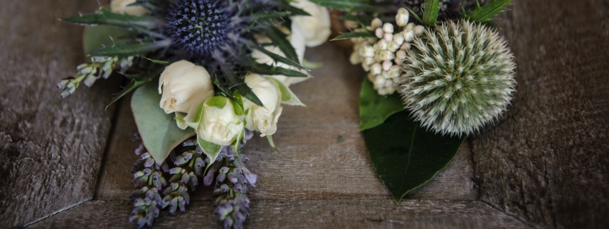 Wedding buttonholes thistles roses and lavender
