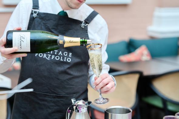 Waiter pouring champagne at an event at The Wallace 