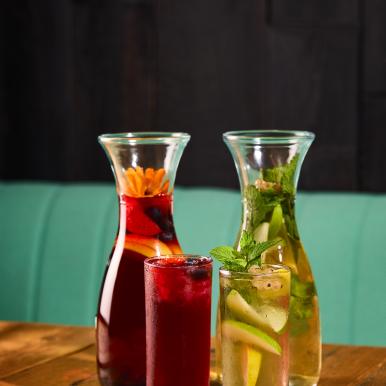 Jugs of Cold Brewed Berry Hibiscus and Tropical Green Iced Teas