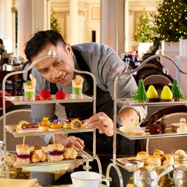 Chef applying the finishing touches to an afternoon tea