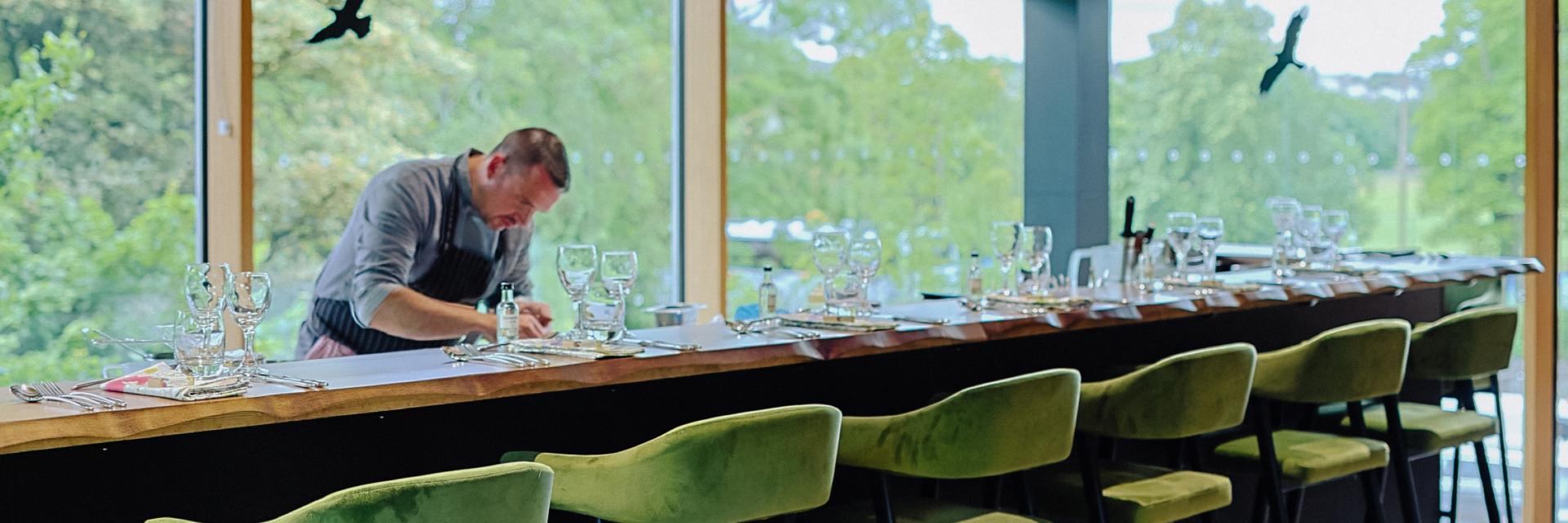 Chef preparing a meal at the chef table in the Demonstration Kitchen. 