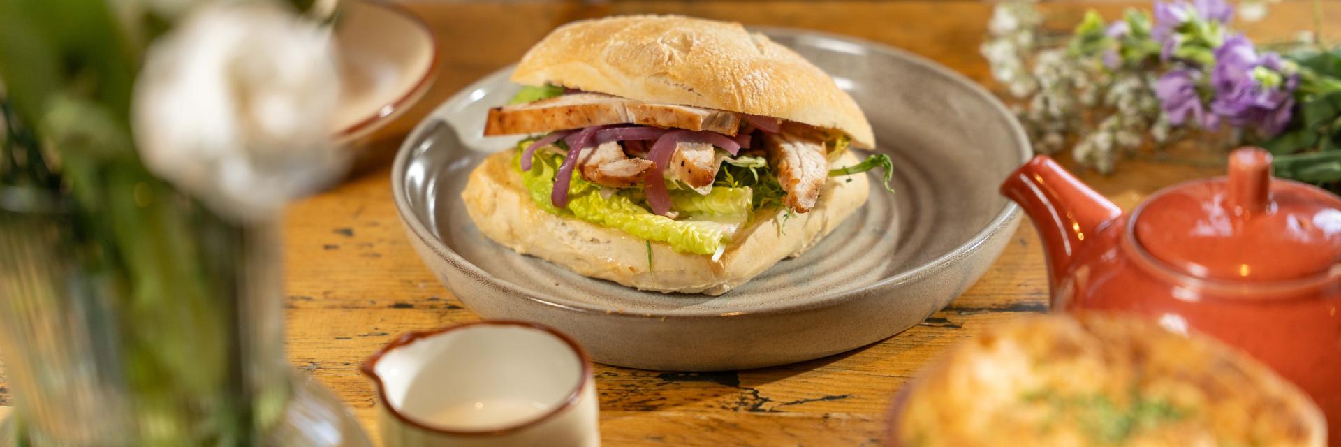Chicken Caesar Sandwich on a wooden table. 